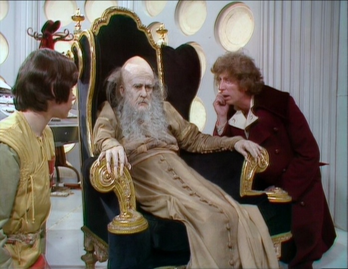 Adric and the Fourth Doctor conversing with the Keeper of Traken