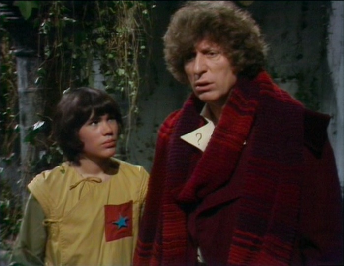 Adric (Matthew Waterhouse) and the Fourth Doctor (Tom Baker) in a decaying room deep in the TARDIS