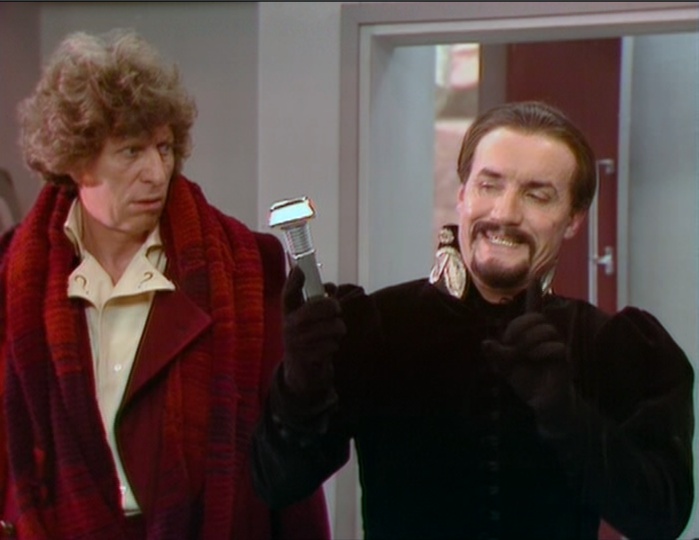 The Fourth Doctor (Tom Baker) looks on in dismay at the Master (Anthony Ainley)